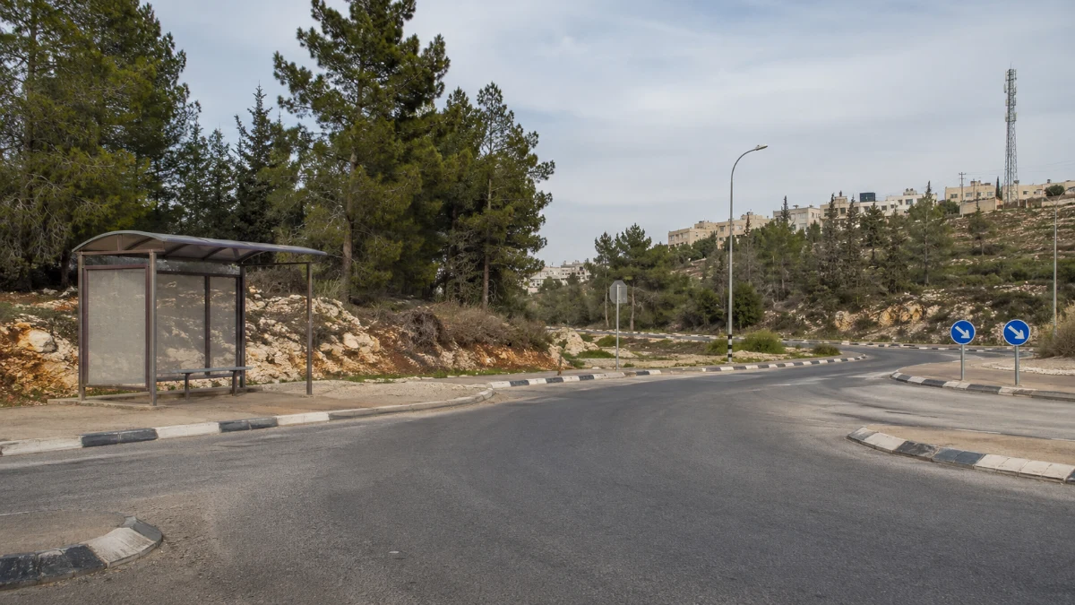 תחנת אוטובוס בצומת הכניסה לעפרה בשעות היום, ללא אנשים וללא המחשה אלימה